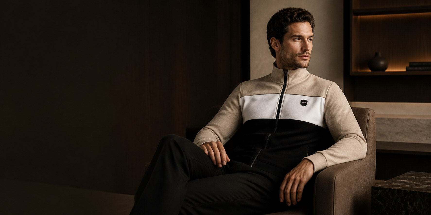 Man wearing a beige, white and black new-season zip jacket